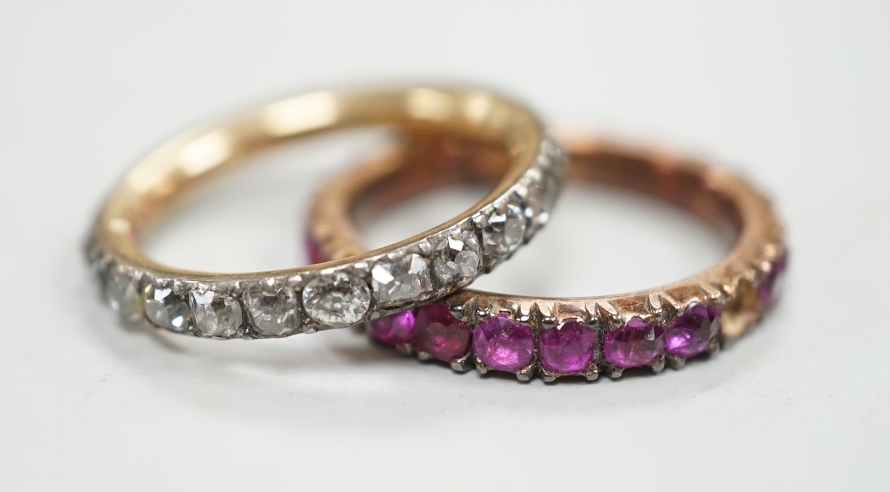 An antique yellow metal and diamond set full eternity ring (stone missing), size L and a similar pink stone set eternity ring.